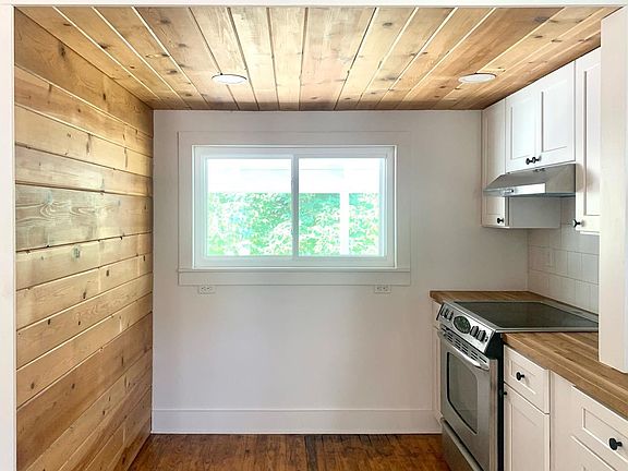 Kitchen "cooking nook" featuring wood accent wall & ceiling