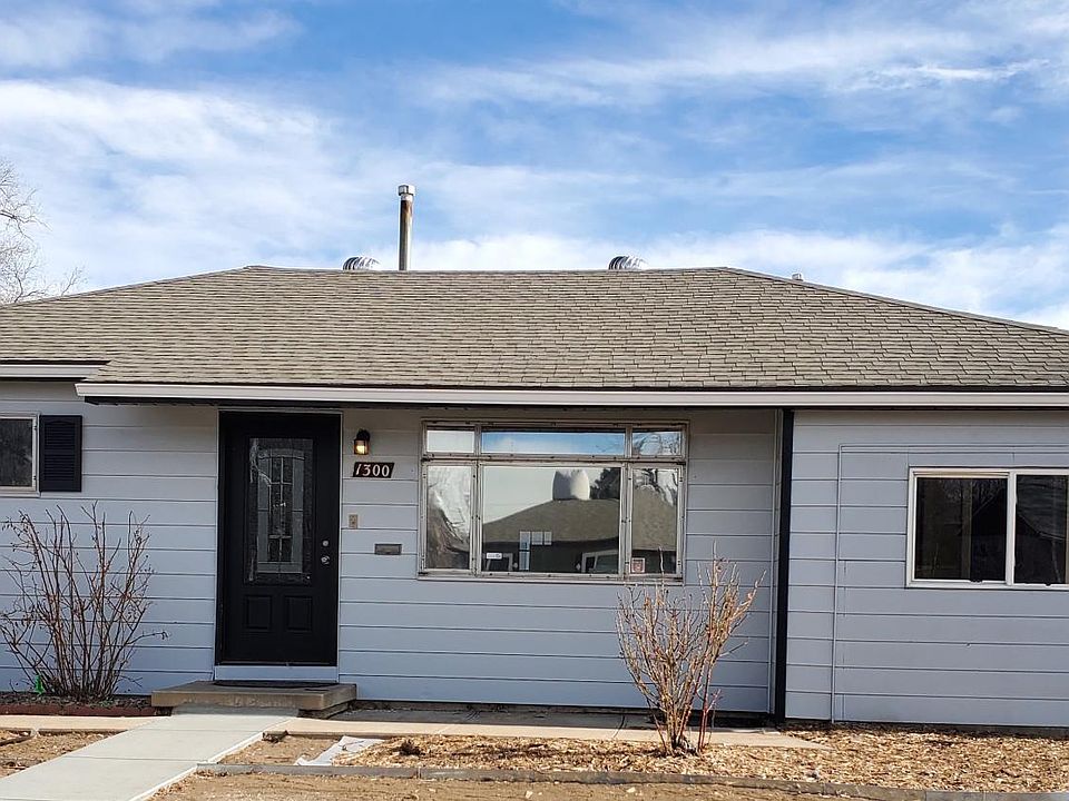 Front view of the house. New gate on the right side. Master bedroom is the window on the right.