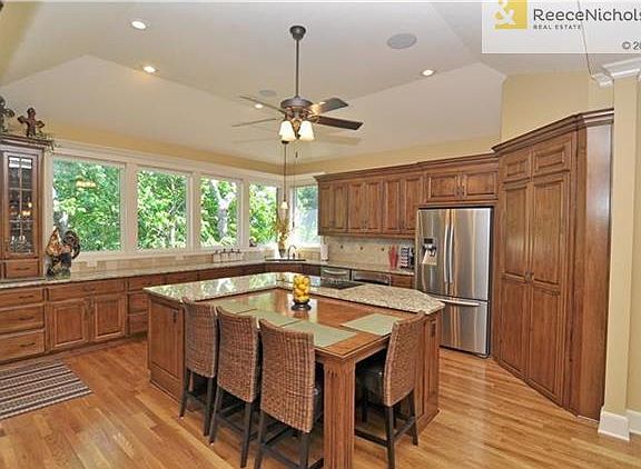 Uniquely designed center island with wood table that slides away for all kinds of flexible seating. Deep drawers, roll-out shelving and walk-in pantry offer tons of storage.