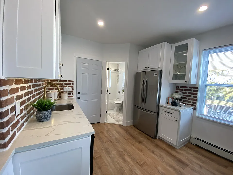 Stainless Refrigerator, Glass Door Cabinet, Quartz Countertops