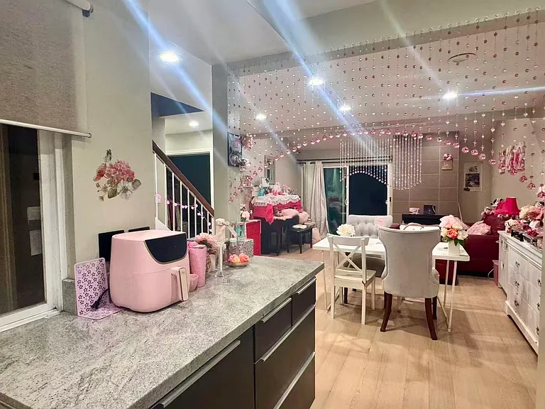 Shared living spaces: the living room and table, and a stairway up to the suite.