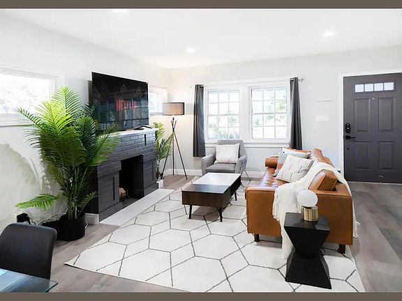 This living room is a testament to clean, well-maintained aesthetics, where comfort meets enjoyment. Pristine furnishings and tasteful decor create an inviting, visually pleasing space. It's a haven for relaxation and entertainment, ensuring your comfort