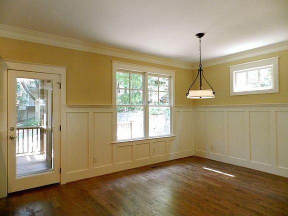 Dining room features classy wainscoting on walls and opens to both kitchen and living room... perfec