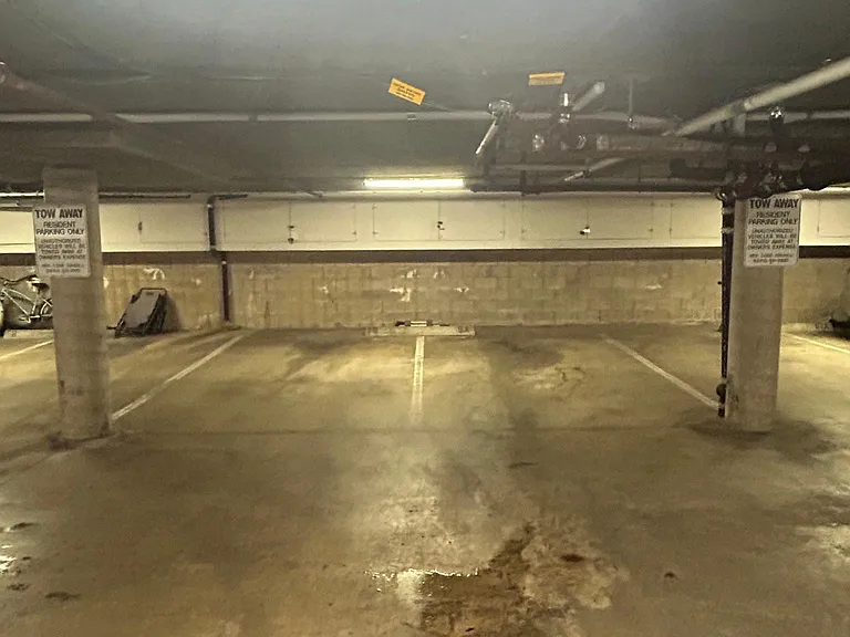 2 side by side garaged parking spaces
storage locker in front of parking spaces