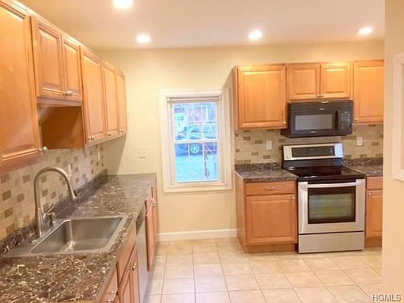 Recently updated country kitchen with black and stainless ap