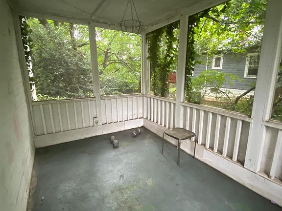 Entrance to screened porch is from the living room, opposite the fireplace wall. It has a light fixture.