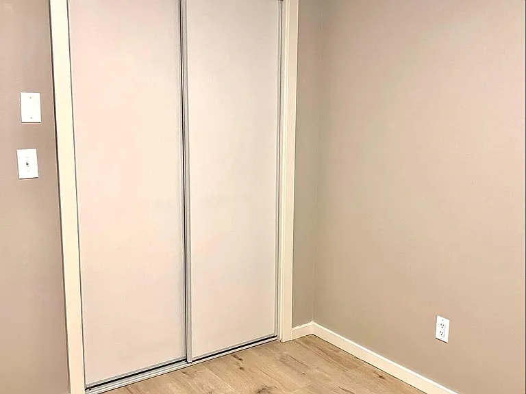 Smaller Bedroom. New flooring, new trim work, new closet doors