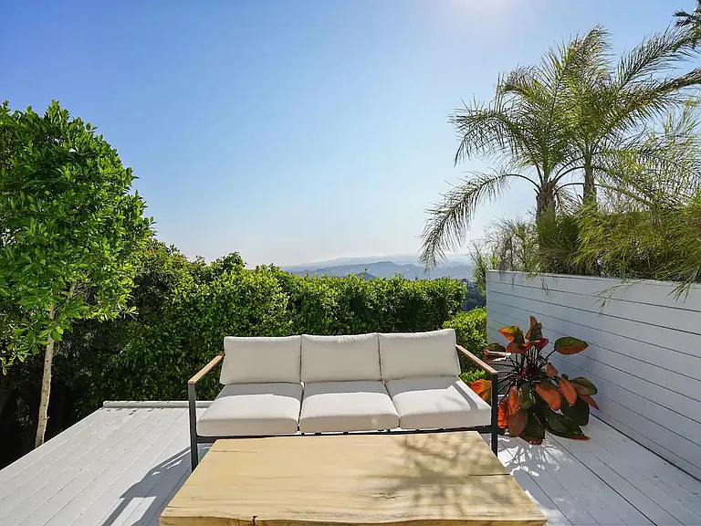 Step out onto the outside balcony directly from the primary bedroom, and soak in the beauty of the surrounding views.