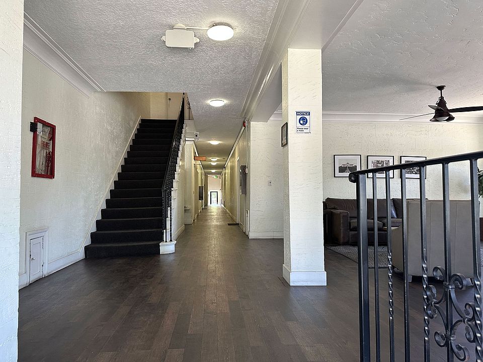 Front lobby view of hallway and stairway to apartment units at Molino Del Mar Apartments in Pasadena, California.