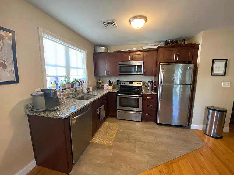 Kitchen features granite counters and stainless steel appliances.