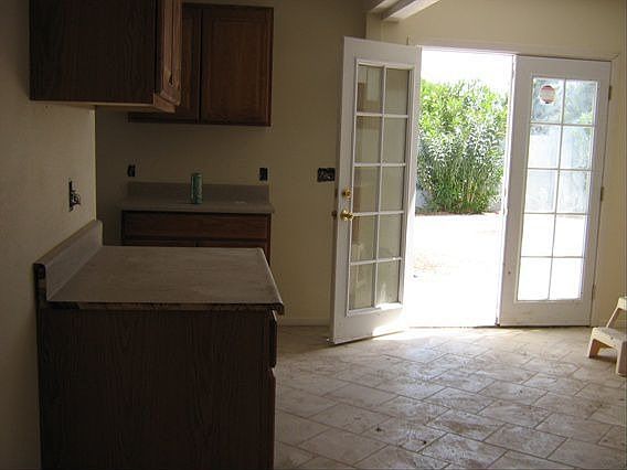 Bright brand new kitchen w/ french doors to pool.