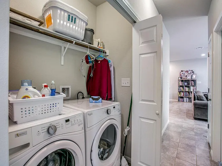 located in hallway across from 2 secondary bedrooms...