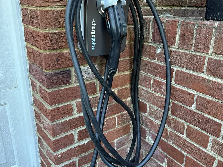 50-amp EV charger with 23-foot cable, in driveway.