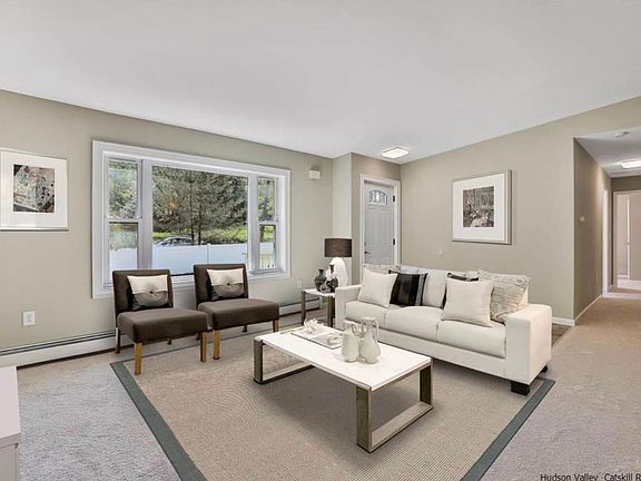 Living room with large window overlooking front yard.