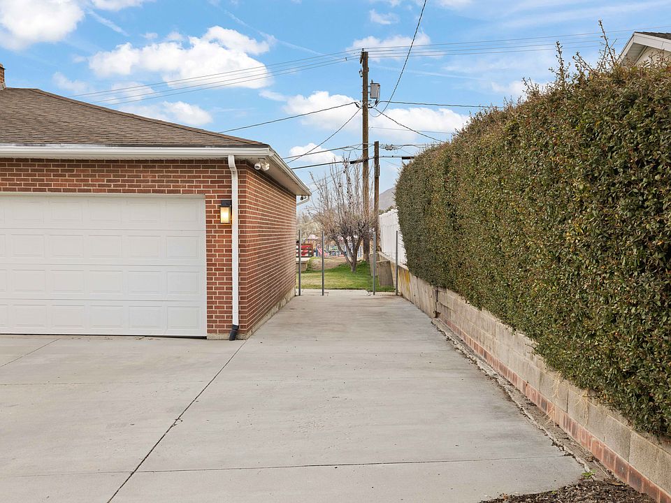 As the downstairs tenant this is your portion of the driveway (everything between the wall and the garage extending out to the street. Can easily fit two cars in the space.