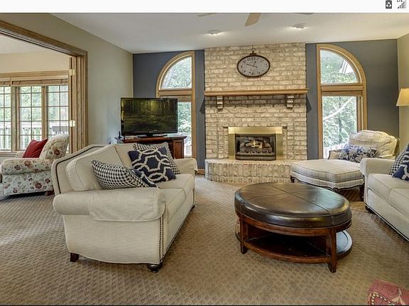 Family room next to 4 season porch. Since new window were installed by the fireplace the wall was painted beige