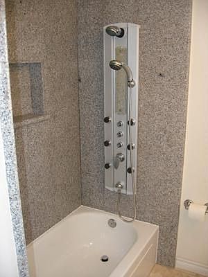 Granite walls and spa wall unit in bathrooms