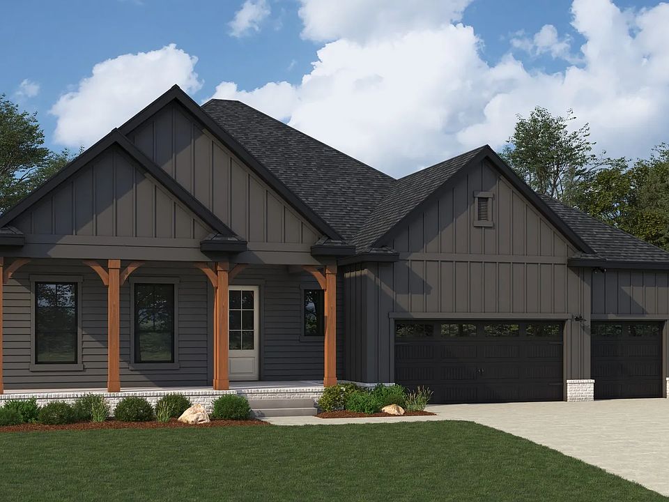 This Brush Creek home showcases sleek black siding with wooden accents and a charming gable roof.