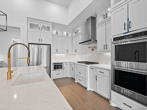 The kitchen has goregous white tile backsplash.