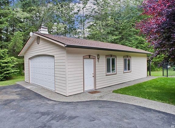 Concrete slab walkway leading to the detached 2-car shop.