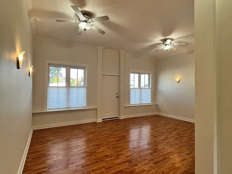 Living Area has high ceilings, fan lights, front door with street access