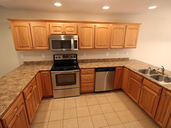 Amish kitchen cabinets and stainless steel Whirlpool appliances