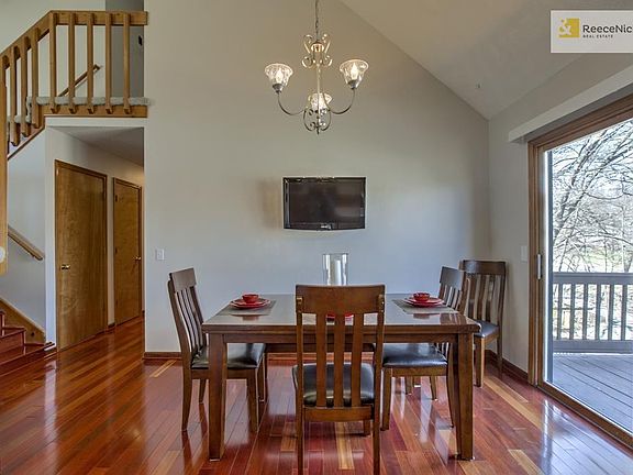 Newer Brazilian cherry wood floors in kitchen, dining area, hallway and stairs.  Large dining area with new light fixture.