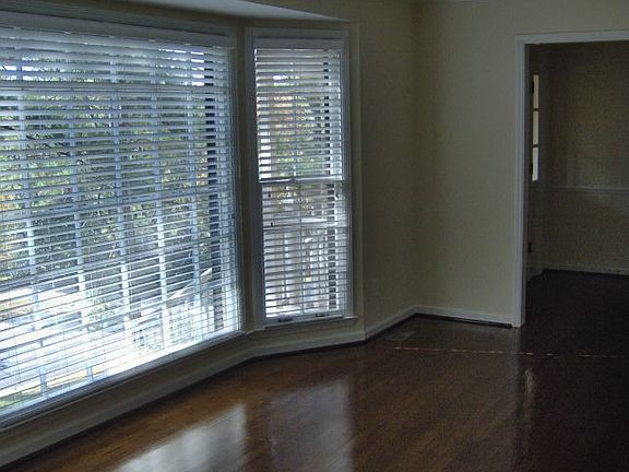 Living room with fabulous bay window and beautiful hardwood floors.