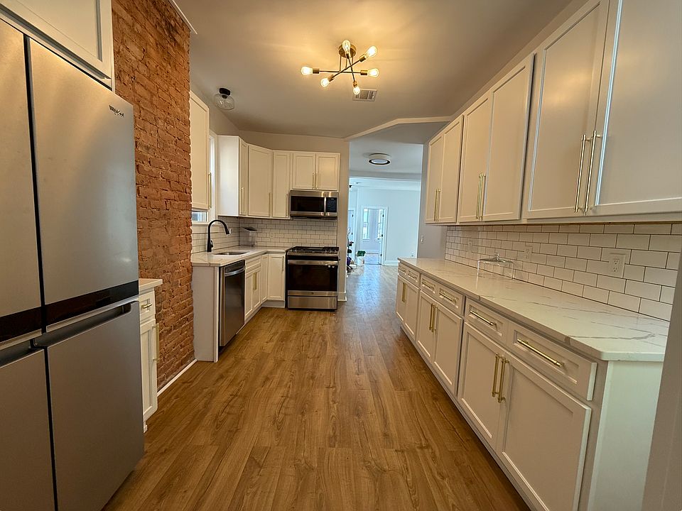 Large kitchen with brick accent wall