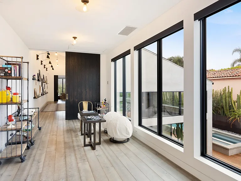 Large windows allow for plenty of natural light and views of the pool.
