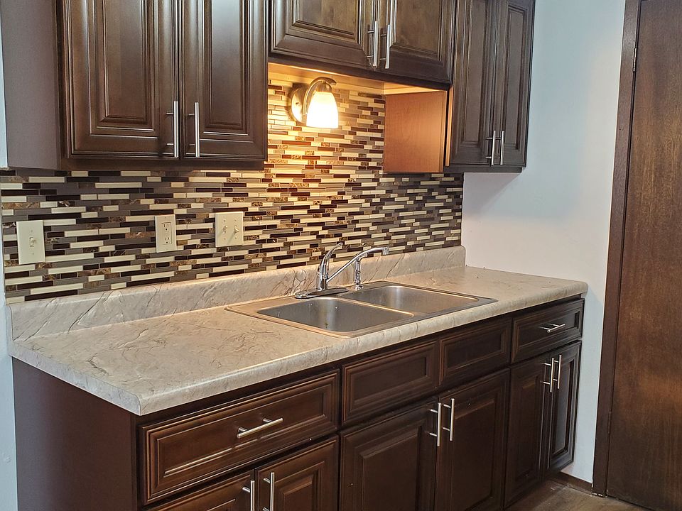 Rich Wood Cabinets with Designer Tile Backsplash