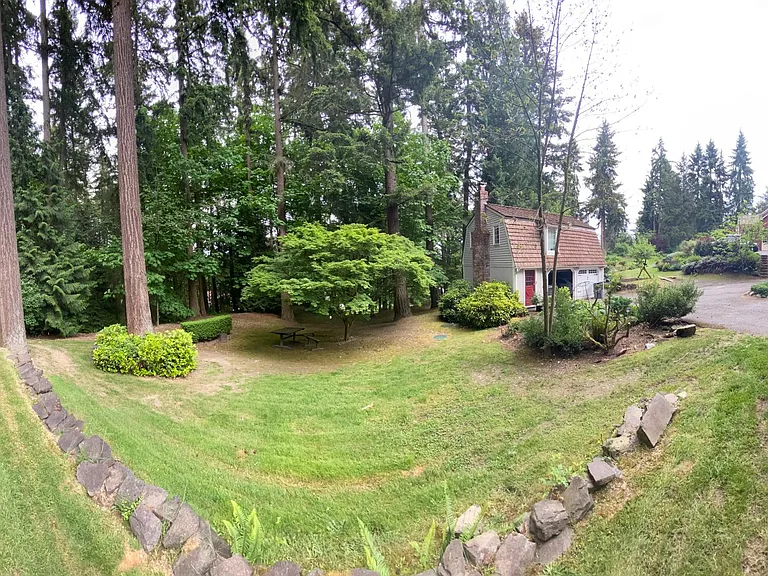 Pano of Yard and garage on a spring day, mostly cloudy