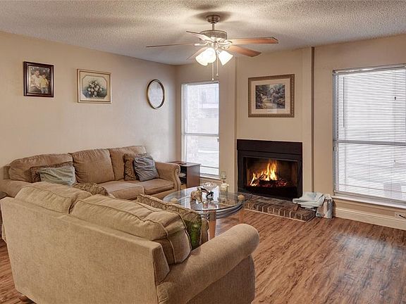 ANOTHER VIEW OF THE LIVING ROOM WITH WOOD-BURNING FIREPLACE