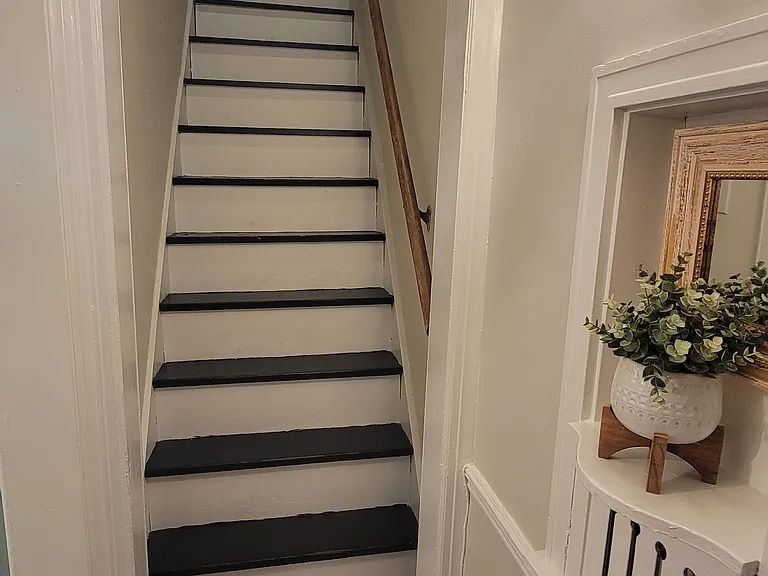Stairs to third bedroom and small second bath.
