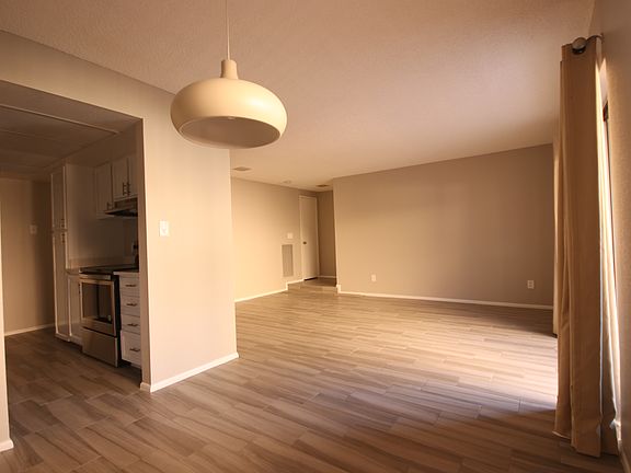 4 View from Dining to Kitchen and Condo Entrance, Light from Patio