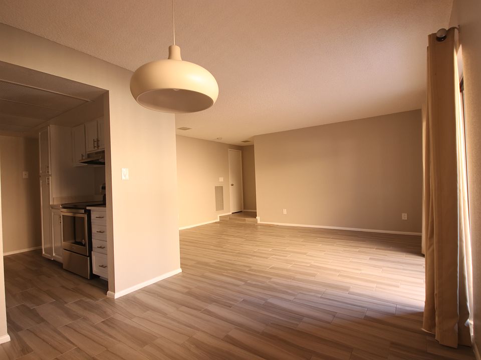 4 View from Dining to Kitchen and Condo Entrance, Light from Patio