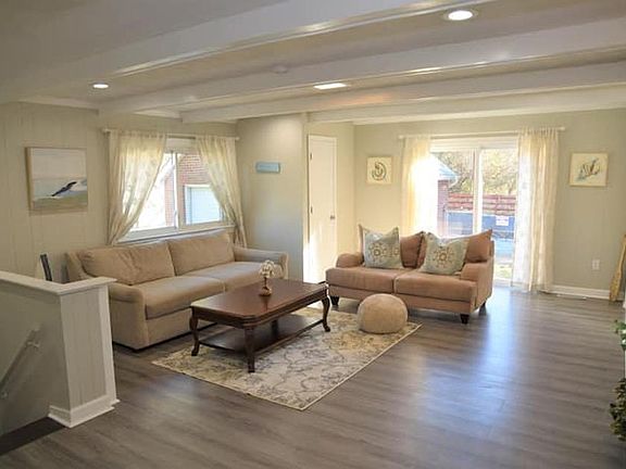 Family Room - Enjoy watching the game or entertaining friends or family in this spacious living space with a poolside view.