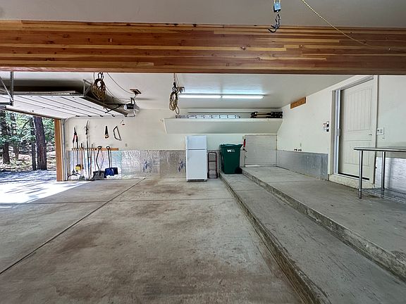 3-car garage, side view. Hooks for canoes/kayaks, bikes. Workbench.