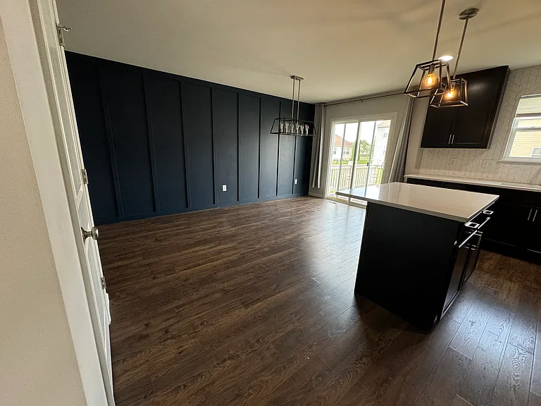 Stunning accent wall in eat-in dining space with access to backyard deck