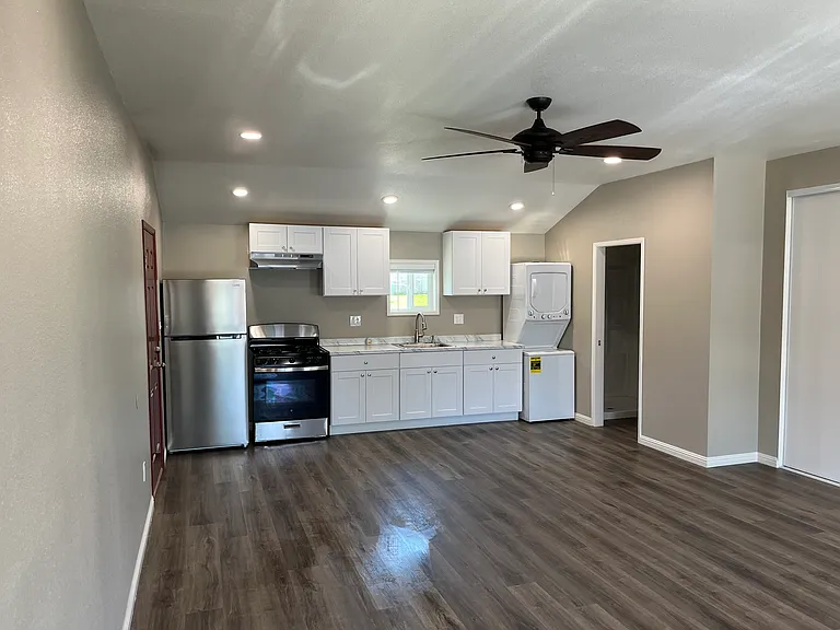 Full view of the kitchen to the right would be your bathroom and closet and bedroom is to The behind me as ceiling fan and split air