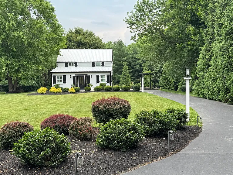 Exterior view from the end of the driveway of the main house.