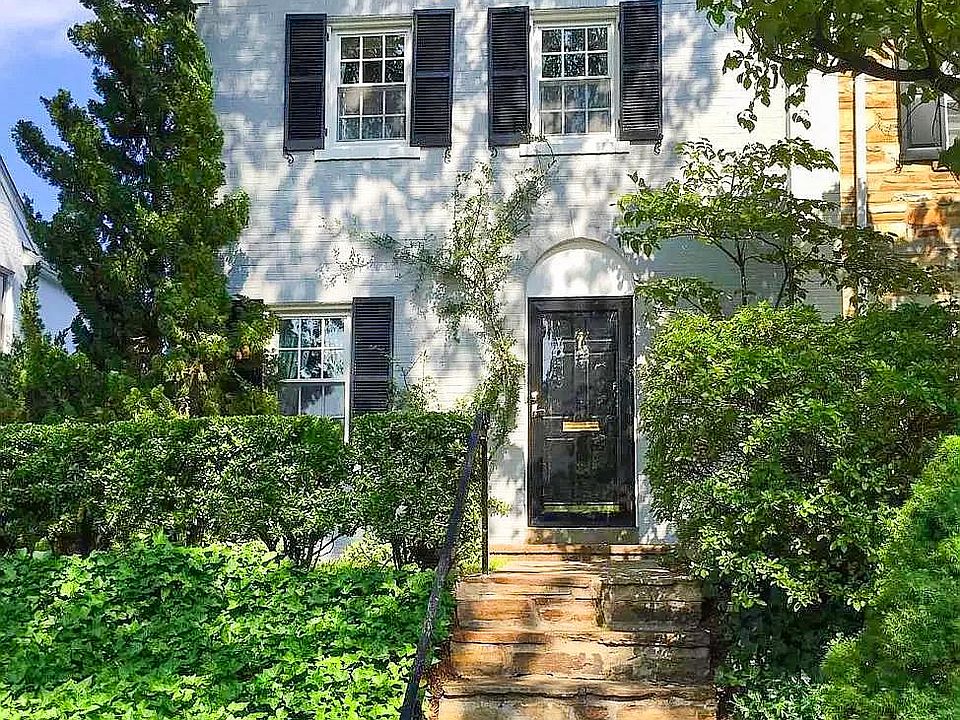 View from the street with a reserved parking spot in front of the townhouse.