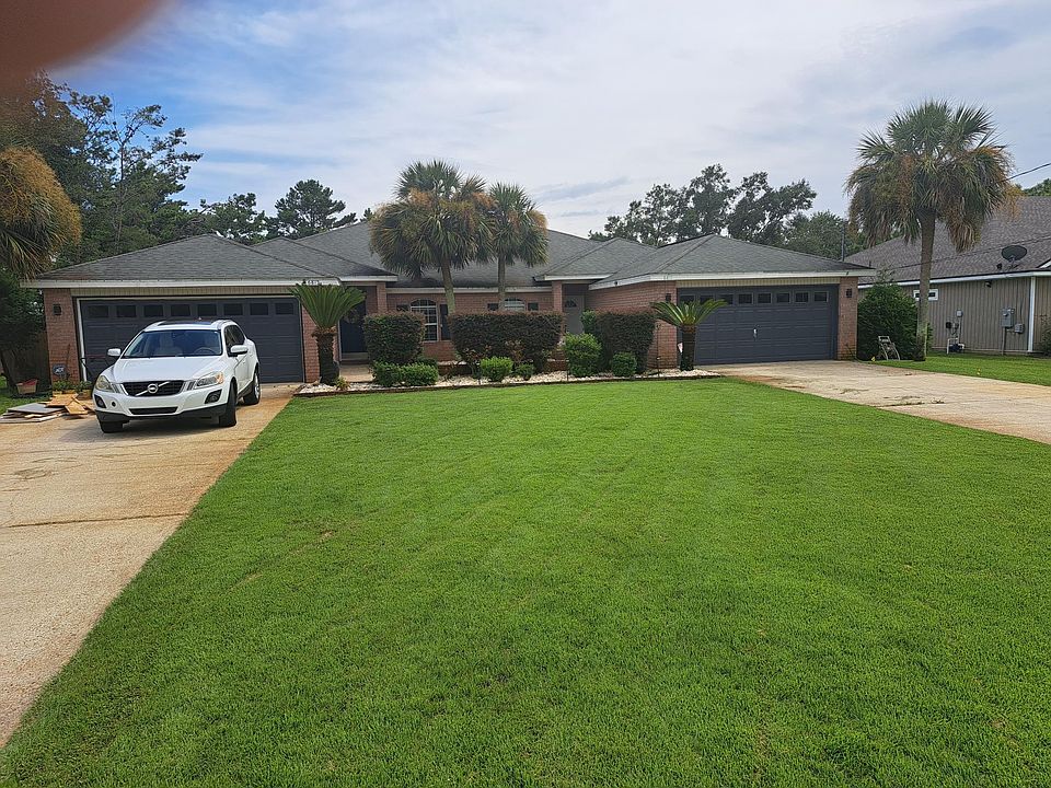View from street, entrance courtyard and double car garage with plenty of storage.