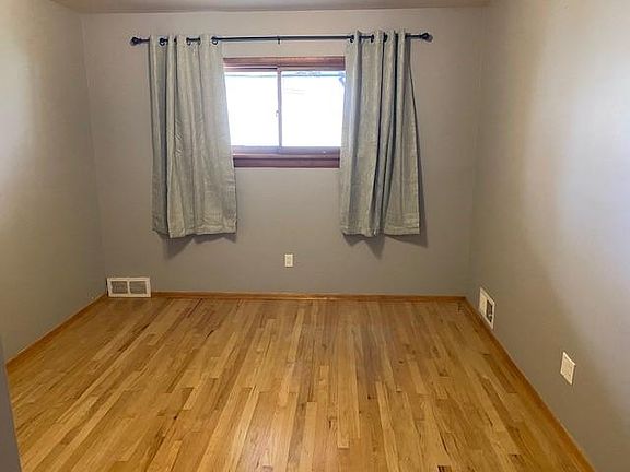 Upper level bedroom has hardwood floor