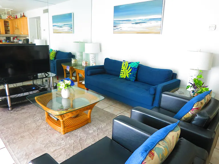 The sunny living room has sliding-door access.