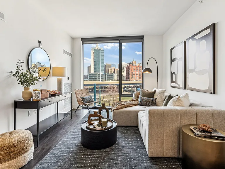 Modern city comfort _ a sunlit living room where sleek design meets serene views.