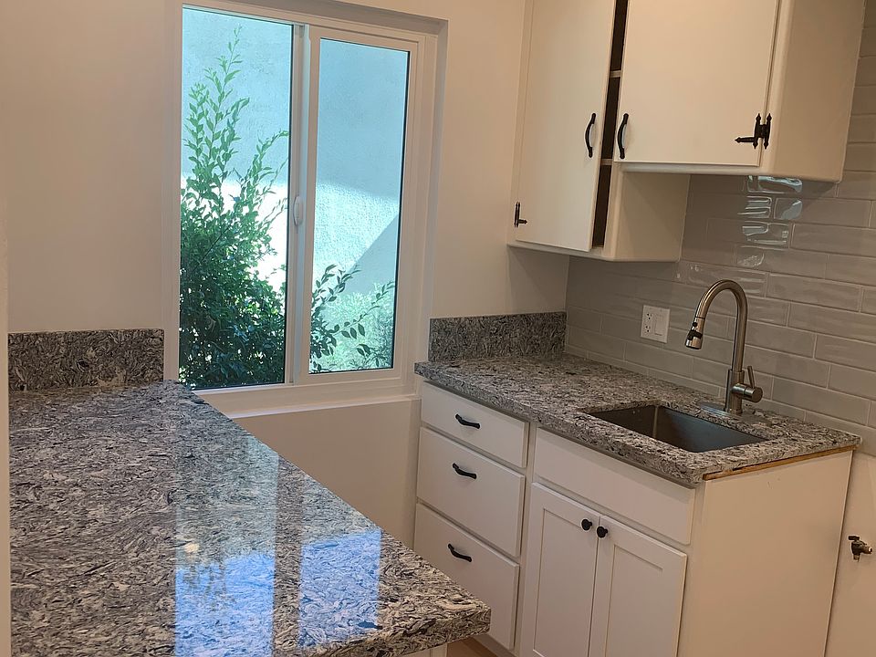 New kitchen cabinets, quartz countertops and subway tile. New window and lots of lighting.