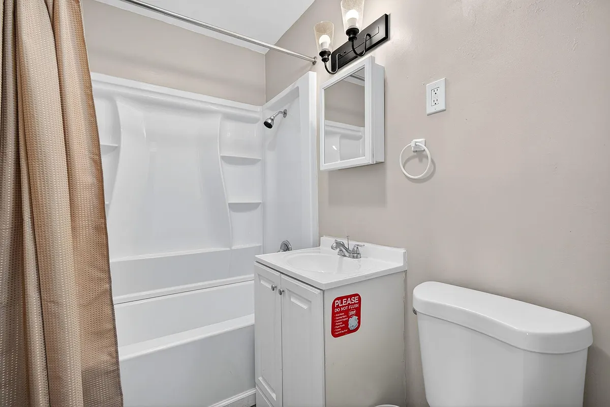 Bathroom labeled a with a bathtub / shower combo. - Gerard Ct