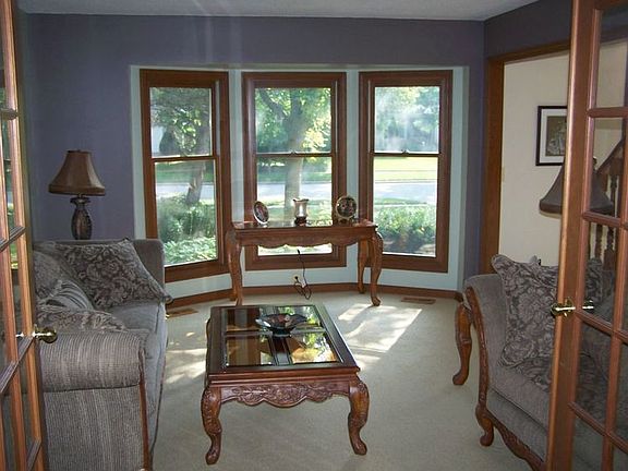  The living room opens up through glass french doors to the dining room.