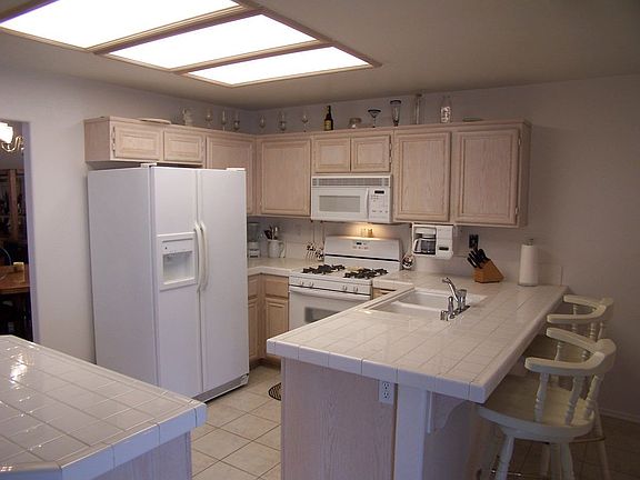 All White Appliances and Tiled Countertops